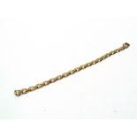 A 9 CARAT GOLD BRACELET of fancy hollow links, to a hidden box clasp with safety catch, 20cm long,