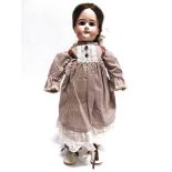 A LANTERNIER BISQUE SOCKET HEAD DOLL with a replacement dark brown wig, fixed brown paperweight