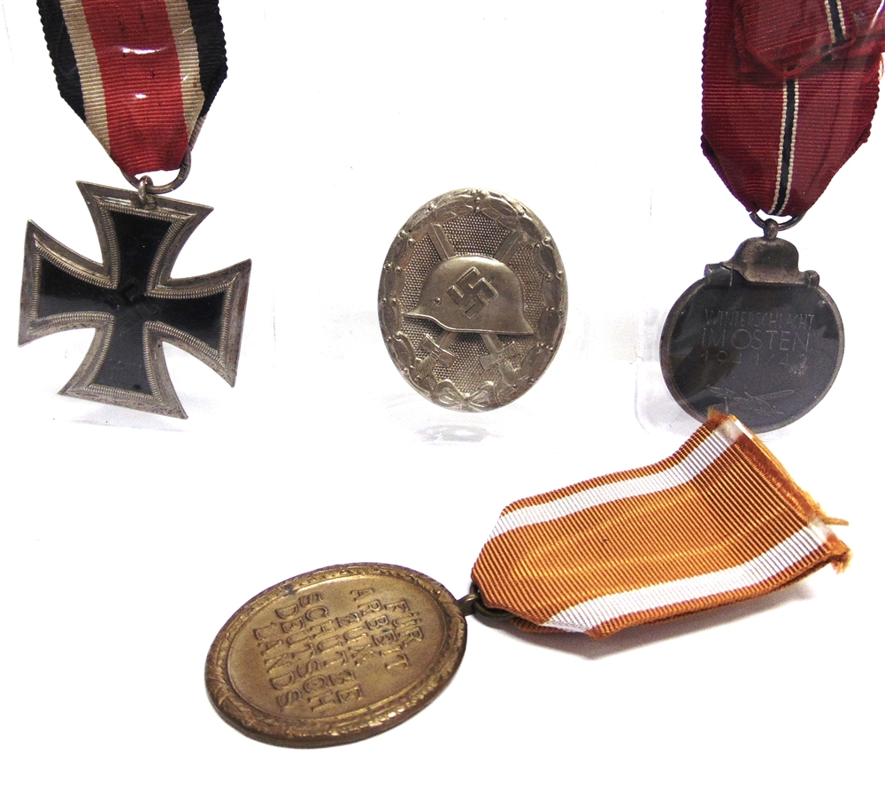 A SECOND WORLD WAR GERMAN THIRD REICH GROUP OF FOUR MEDALS comprising the Iron Cross Second Class;