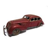 A GERMAN TINPLATE STREAMLINED TOURER circa 1930s, red and silver, with driver figure and