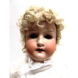 A HEUBACH OF KOPPELSDORF BISQUE SOCKET HEAD DOLL with a curly blonde wig, sleeping blue glass eyes