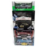 FIVE 1/18 SCALE DIECAST MODEL CARS including U.S. muscle cars, each mint or near mint and boxed.