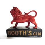 A BOOTH'S GIN PAINTED PLASTER POINT-OF-SALE FIGURE in the form of a prowling red lion, on a black