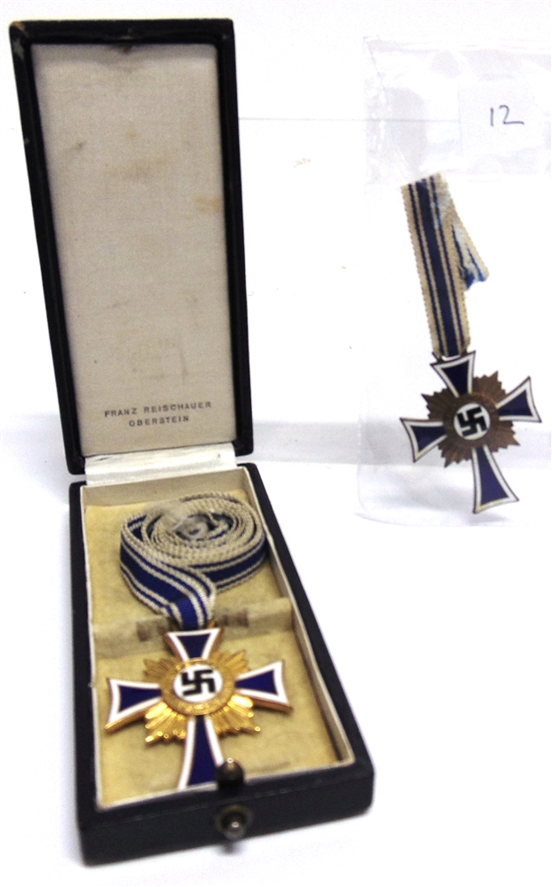 A GERMAN THIRD REICH MOTHER'S CROSS IN GOLD by Franz Reischauer Oberstein, cased; together with a