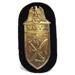 A GERMAN THIRD REICH NARVIK CAMPAIGN SHIELD gilt washed, on its cloth backing.