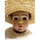 A VERNON SEELEY [REPRODUCTION BRU] BISQUE SOCKET HEAD DOLL lacking wig, with fixed blue