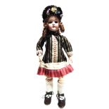 A HAMBURGER & CO. BISQUE SOCKET HEAD DOLL with a replacement auburn ringlet wig, sleeping brown