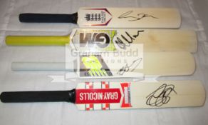 A group of four mini-bats signed by the current England cricketers Alastair Cook, Ben Stokes,