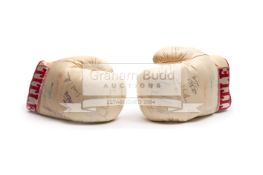 A pair of autographed boxing gloves, a pair of white Title gloves,