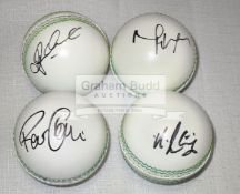 A group of four white leather cricket balls signed by the Australian players Glenn Maxwell,