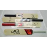 A group of four mini-bats signed by the current England cricketers Joe Root, Jonny Bairstow,