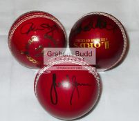 A trio of red leather cricket balls signed by West Indies cricketing legends Clive Lloyd,