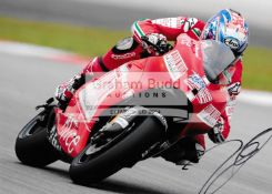 A group of four photographs signed by MotoGP greats Nicky Hayden, Casey Stoner,