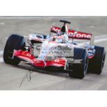 Nine photographs signed by F1 drivers, all 10 by 8in.