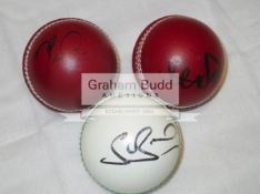 A group of six leather cricket balls signed by current England players Chris Woakes, James Anderson,