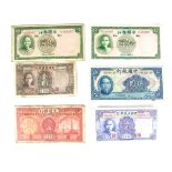 A collection of six old Chinese bank notes.