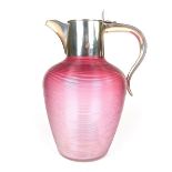 A Victorian silver and cranberry glass claret jug.