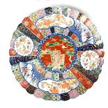 A large Japanese Imari charger, Meiji period (1868 - 1912). Of circular, scalloped form. 16.