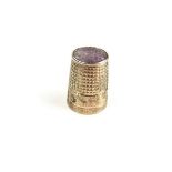 A Victorian silver thimble.