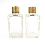 A pair of George VI gilt silver topped engraved glass perfume bottles.