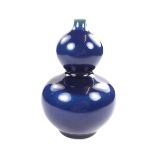 A Chinese blue monochrome double gourd vase, 20th century.