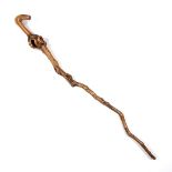 A natural branch walking cane. Composed of a single section of gnarled wood branch. 36.4 in (92.