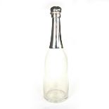 A Victorian silver topped clear glass champagne bottle. With a hinged lid and glass stopper.