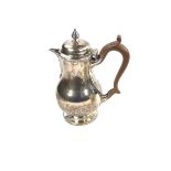 A Victorian silver hot water pot.