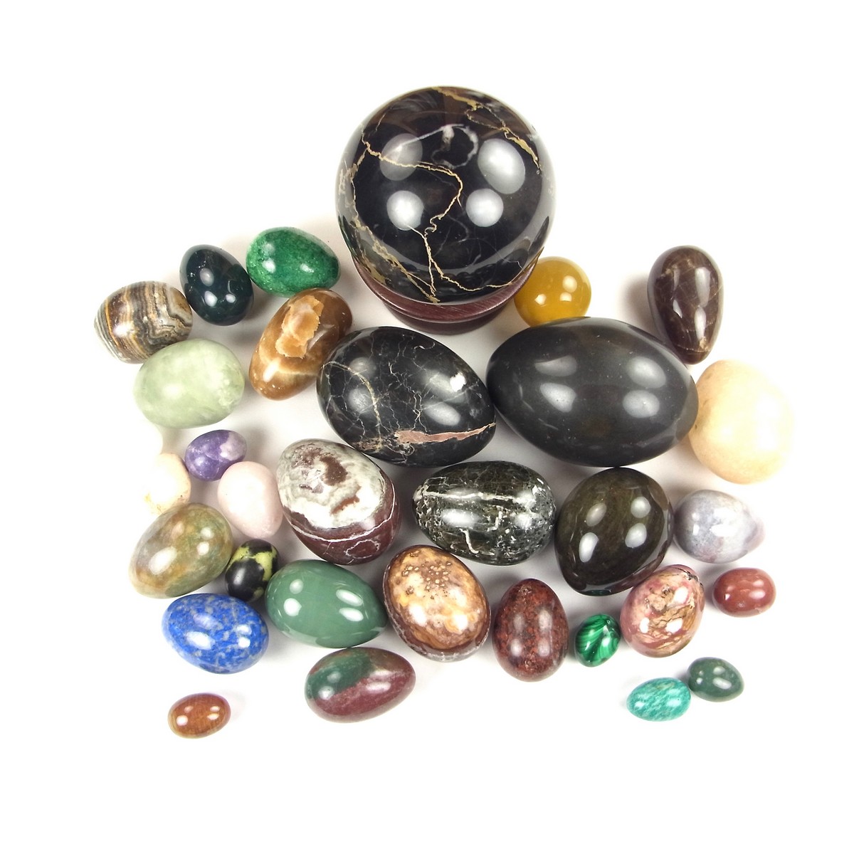 Large collection of polished mineral egg and sphere specimens.