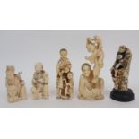 A Japanese ivory okimono a man and child standing with a sack, 9cm high, a carving of a toy