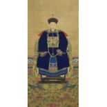 A Chinese ancestral portrait of a Mandarin seated on a chair resting on a carpet of phoenix in