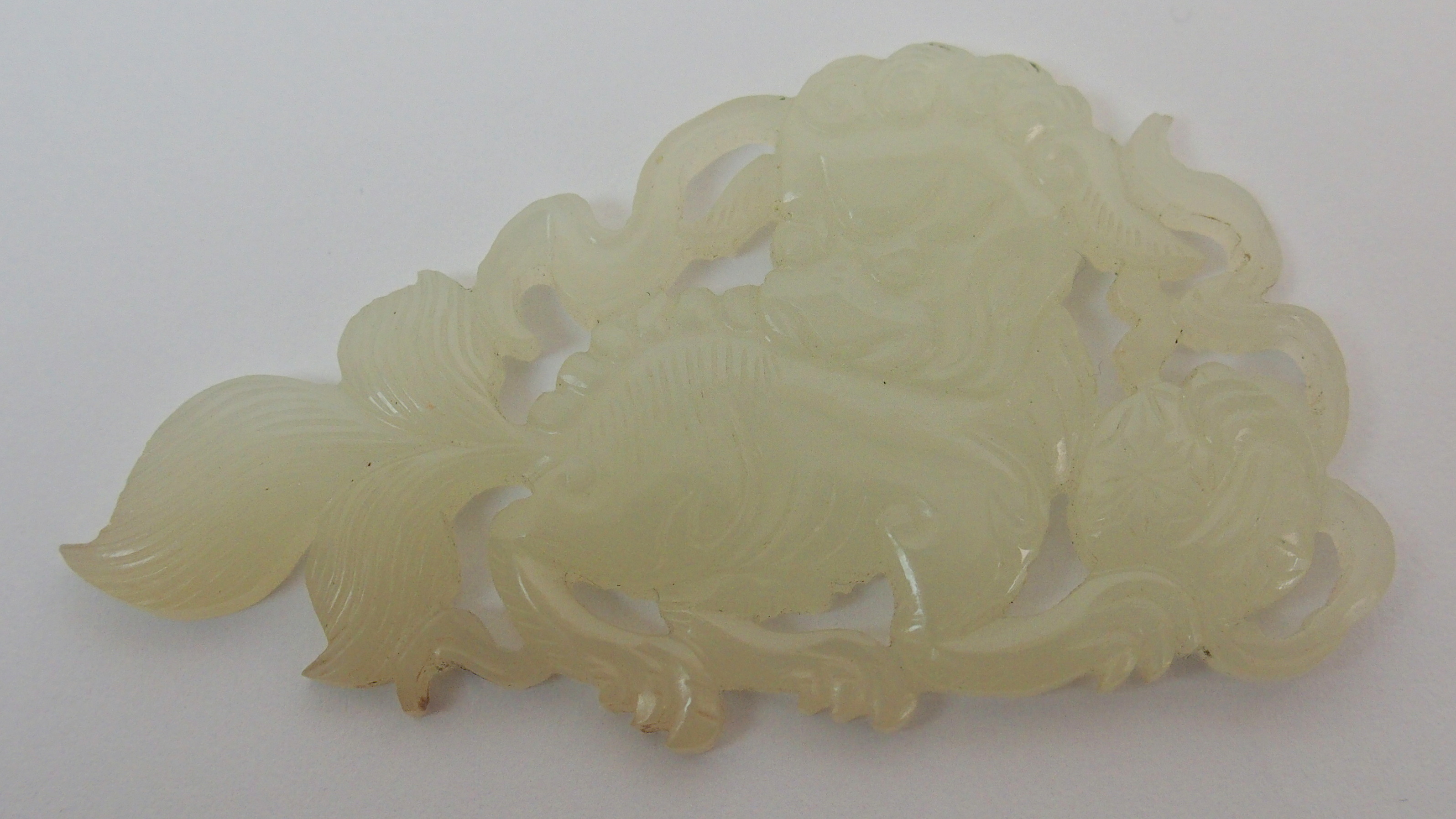 Two Chinese jade mounts carved as shishi with brocade balls and ribbons, 5.5cm wide and an Indian - Image 8 of 10
