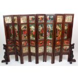 A Chinese eight-fold screen with raised soapstone panels of figures, calligraphy and fruit with a