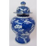 A Chinese blue and white baluster jar and cover painted with blossoming branches on honeycomb