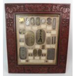 An early 20th Century framed collection of Japanese old gold and silver coins (copies) the frame