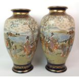 A pair of large Satsuma baluster vases painted with panels of ladies and children on river banks