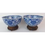 A pair of Chinese blue and white bowls painted with lotus and scrolling foliage, within double