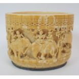 A Burmese ivory tusk vase carved with a procession of figures, elephants, carriage, boat within