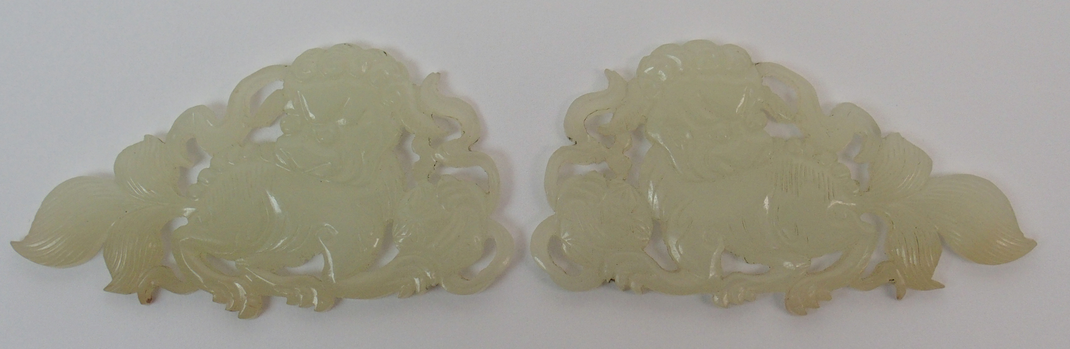 Two Chinese jade mounts carved as shishi with brocade balls and ribbons, 5.5cm wide and an Indian - Image 4 of 10