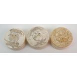 Three Japanese ivory boxes one carved with lions, another monkeys and the other flowers, (