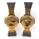 A pair of Japanese Shibayama style drum-shaped square section vases each drum face onlaid, with