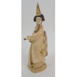 A Japanese ivory okimono of a lady standing in full dress and holding a fan, signed on a red