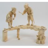 A Japanese sectional ivory okimono with two men fishing from a rustic bridge, decorated with foliage