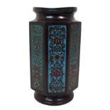 A Chinese bronze and champleve enamel octagonal vase decorated with foliate panels beneath a key