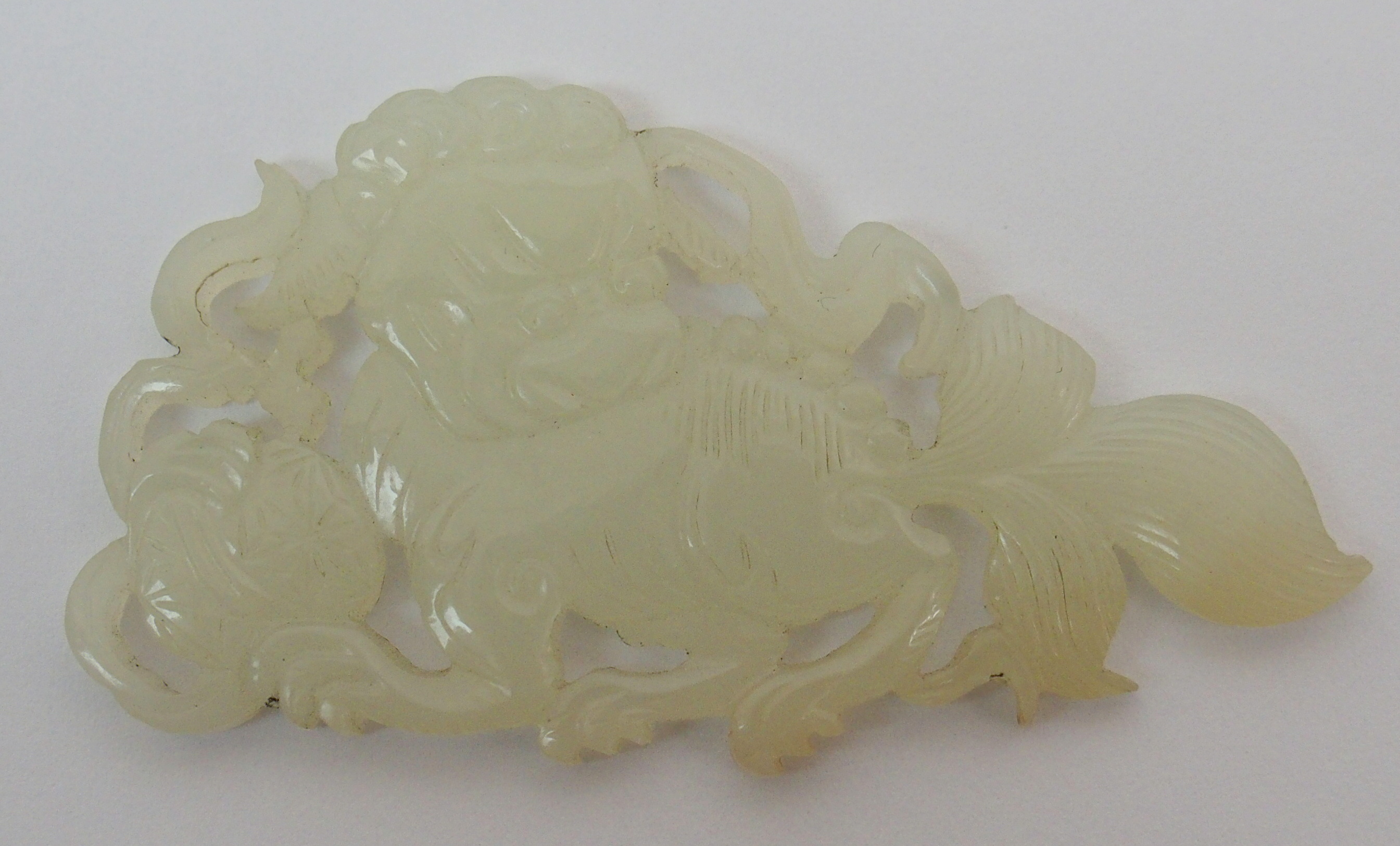 Two Chinese jade mounts carved as shishi with brocade balls and ribbons, 5.5cm wide and an Indian - Image 5 of 10