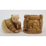 A Japanese ivory netsuke of Daikoku signed, 4cm wide and a netsuke of a cauldron with three figures,