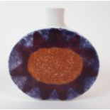 A MINIATURE TROIKA FLAT OVAL VASE with a sunburst design to one side in purple, maroon and