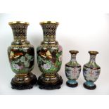 A PAIR OF CHINESE CLOISONNE BALUSTER VASES decorated with flowers and diaper, wood stands, 38cm high