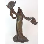 A FRENCH ART NOUVEAU PATINATED SPELTER LADY LAMP modelled standing with arms outstretched holding