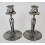 A PAIR OF ARCHIBALD KNOX STYLE ENGLISH PEWTER CANDLESTICKS the tapering open cage body